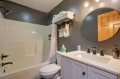 a bathroom with a sink and a toilet and a mirror at Havenwood in Logan