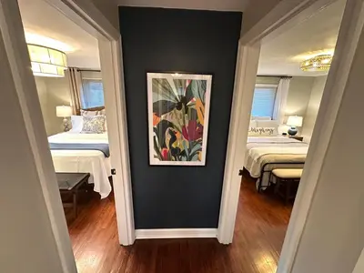 a room with two beds and a painting on the wall at The Sleepy Tiki - game room, tiki lounge, firepit in Mason