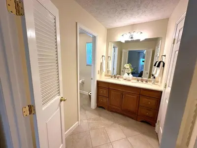 a bathroom with a sink and a mirror at Mason Ohio Home large private yard firepit game room in Mason