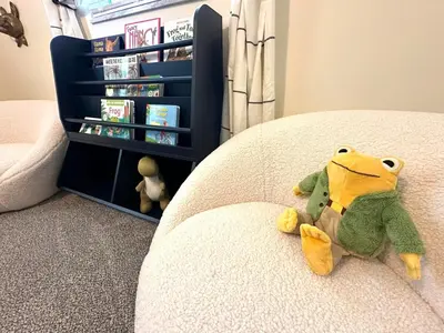 a stuffed animal sitting on the corner of a bed at Mason Ohio Home large private yard firepit game room in Mason