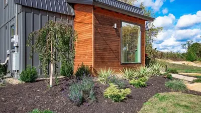 a garden in front of a house at Modern Cabin next to Salt Fork State Park