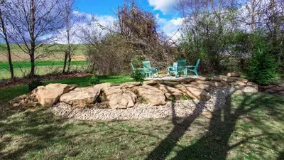 two chairs sitting on top of a rock wall at Modern Cabin next to Salt Fork State Park