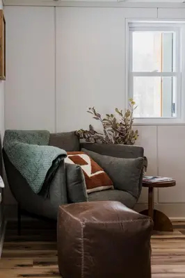 a living room with a couch and a window at Modern Cabin next to Salt Fork State Park
