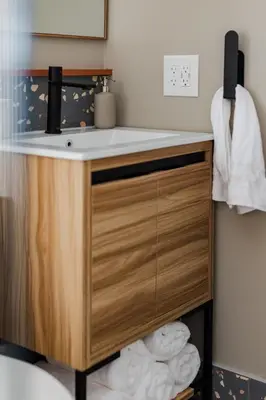 a bathroom vanity with a sink and towels at Modern Cabin next to Salt Fork State Park