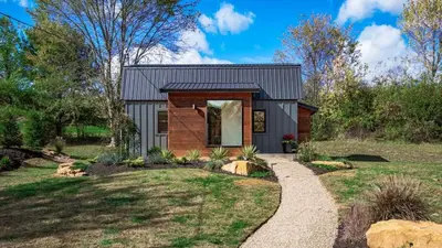 a contemporary home with a brick and wood exterior at Modern Cabin next to Salt Fork State Park