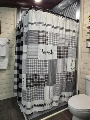 a black and white shower curtain in a bathroom at Hot Tub & Firepit Your Winter Blues Retreat in Amherst