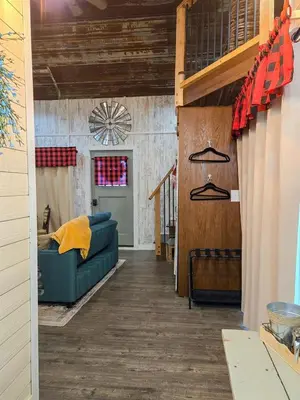 a living room with a blue couch in a room at Hot Tub & Firepit Your Winter Blues Retreat in Amherst