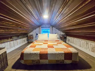 a bedroom with a large bed in a building at Hot Tub & Firepit Your Winter Blues Retreat in Amherst