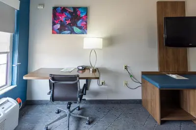 a room with a desk with a chair and a computer at Countryside Inn and Suites in Mount Orab