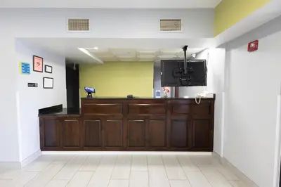 a lobby with a large wooden door and a television at Countryside Inn and Suites in Mount Orab