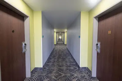 a hallway of an office building with yellow and white walls at Countryside Inn and Suites in Mount Orab