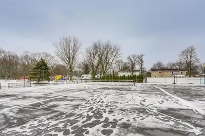 an empty parking lot with snow on it at Close to Hospitals and Downtown Cleveland Home in North Olmsted