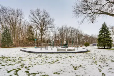 a park covered in snow with a playground at Close to Hospitals and Downtown Cleveland Home in North Olmsted