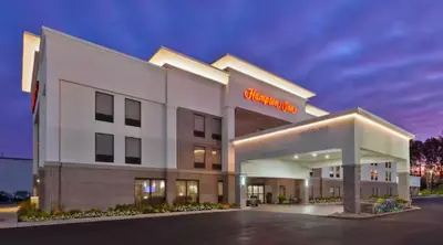 a hotel with a sign on the front of it at Hampton Inn in Marysville