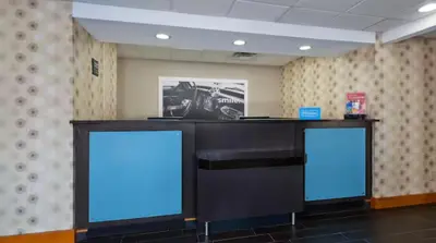 a desk with two blue screens in a room at Hampton Inn in Marysville