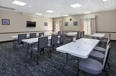 a conference room with white tables and chairs at Hampton Inn in Marysville