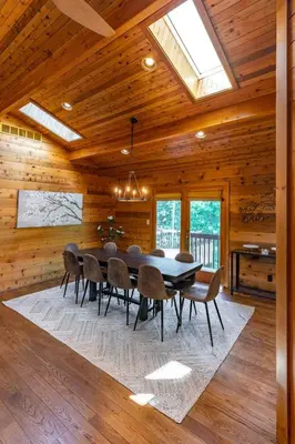 a wooden dining room with a table and chairs at Nature Spa House | •Pool •Hot Tub •Sauna •Pvt Lake in New Richmond