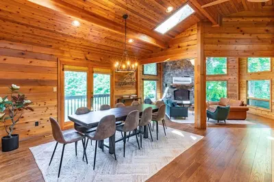 a dining room with a table and chairs at Nature Spa House | •Pool •Hot Tub •Sauna •Pvt Lake in New Richmond