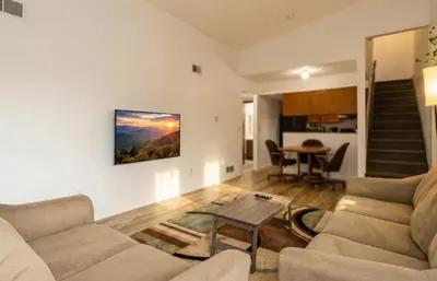 a living room with two couches and a table at 3BR Townhouse with Free Parking Near Downtown Ohio in Reynoldsburg