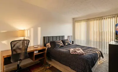 a bedroom with a bed and a desk and a chair at 3BR Townhouse with Free Parking Near Downtown Ohio in Reynoldsburg