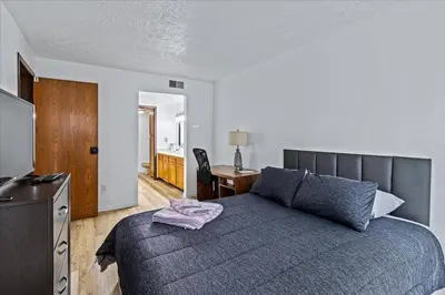 a bedroom with a bed and a desk in it at 3BR Townhouse with Free Parking Near Downtown Ohio in Reynoldsburg