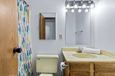 a bathroom with a sink and a toilet and a mirror at 3BR Townhouse with Free Parking Near Downtown Ohio in Reynoldsburg