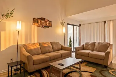 a living room with a couch and a table at 3BR Townhouse with Free Parking Near Downtown Ohio in Reynoldsburg