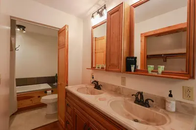 a bathroom with a sink and a toilet and a mirror at Golden goat cabin in Logan