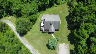an aerial view of a house in the middle of a field at Golden goat cabin in Logan