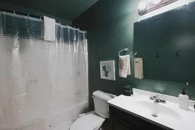a bathroom with a shower and a toilet and a sink at Golden goat cabin in Logan