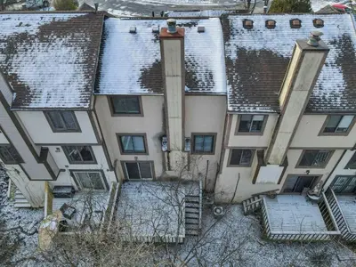 an aerial view of a building with snow covered roofs at Modern Retreat with Forest Views 3BR Near Airport & Downtown in Gahanna
