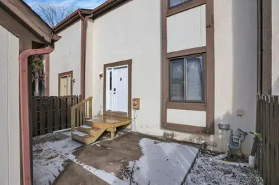 a porch of a house with a door and a bench at Modern Retreat with Forest Views 3BR Near Airport & Downtown in Gahanna