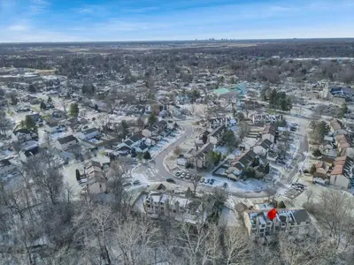 an aerial view of a city with houses and cars at Modern Retreat with Forest Views 3BR Near Airport & Downtown in Gahanna