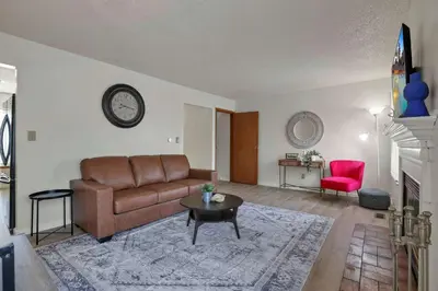 a living room with a couch and a table at Modern Retreat with Forest Views 3BR Near Airport & Downtown in Gahanna