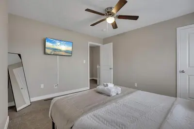 a bedroom with a bed with a ceiling fan at Modern Townhouse in Historic Building Walk to Downtown in Columbus