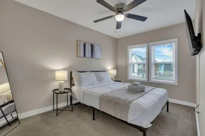 a bedroom with a bed and a ceiling fan at Modern Townhouse in Historic Building Walk to Downtown in Columbus