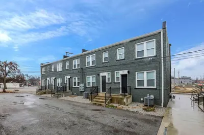 a gray building with white windows on a street at Modern Townhouse in Historic Building Walk to Downtown in Columbus