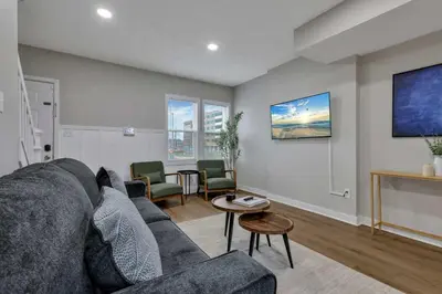 a living room with a couch and a table at Perfect Short Stay in Historic Columbus Walkable Modern & Easy in Columbus