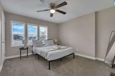 a bedroom with a bed and a ceiling fan at Perfect Short Stay in Historic Columbus Walkable Modern & Easy in Columbus