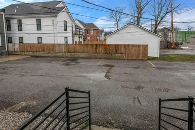an empty parking lot in front of a house at Perfect Short Stay in Historic Columbus Walkable Modern & Easy in Columbus