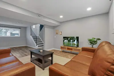 a living room with a couch and a flat screen tv at Modern 4BR Retreat Fenced Yard Near Easton in Columbus