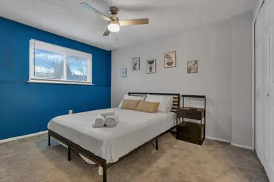 a bedroom with a bed with a blue wall at Modern 4BR Retreat Fenced Yard Near Easton in Columbus