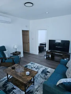 a living room with a couch and a table and a piano at Furnished 2-bedroom Downtown Anderson IN in Anderson