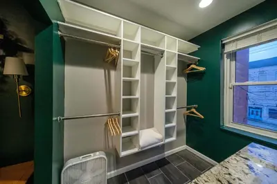 a bathroom with green walls and a walk in shower at Velvet Haus Downtown 3rd Floor Deck Backyard in Cincinnati