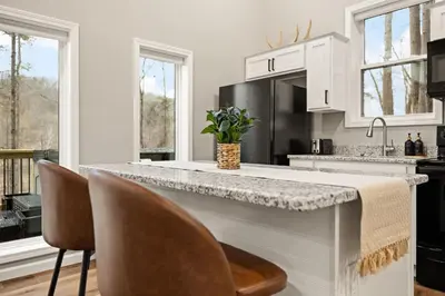 a kitchen with a counter and some chairs at Romantic Secluded Hot Tub, Stargazing, Mt View in Stanton