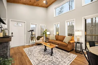 a living room with a couch and a table at Romantic Secluded Hot Tub, Stargazing, Mt View in Stanton