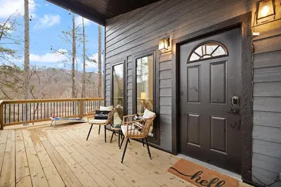 a porch with a door and chairs on a deck at Romantic Secluded Hot Tub, Stargazing, Mt View in Stanton