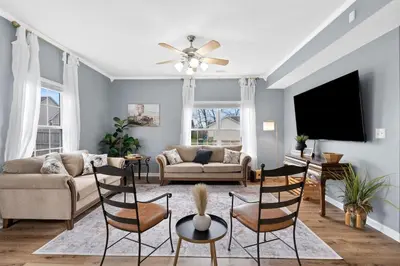 a living room filled with furniture and a flat screen tv at Spacious King Suite, Game Room, Patio, Firepit in Lexington