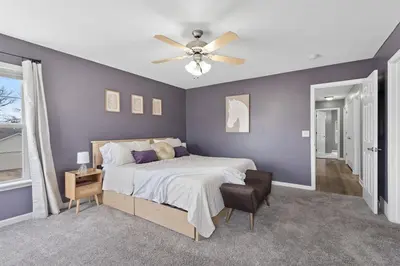 a bedroom with a bed and a ceiling fan at Spacious King Suite, Game Room, Patio, Firepit in Lexington