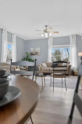 a living room with a couch and tables and chairs at Spacious King Suite, Game Room, Patio, Firepit in Lexington